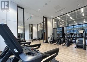Toronto (Newtonbrook East) condo for rent - A gym with treadmills, exercise bikes, and mirrors.