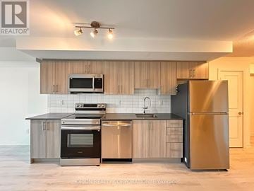 Pickering (Bay Ridges) condo for rent - A modern kitchen with wooden cabinets and stainless steel appliances.