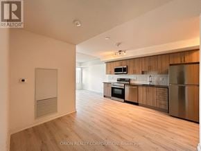 Pickering (Bay Ridges) condo for rent - A kitchen with wooden cabinets and stainless steel appliances.