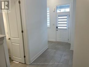 Milton (Bw Bowes) townhouse for rent - A hallway with white doors and a tiled floor.