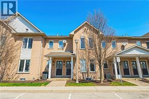 Hamilton townhouse for rent - A large brick house with a front yard and a driveway.