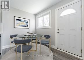 Cambridge fourplex for rent - A dining room with a glass table and chairs.
