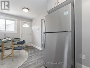 Cambridge fourplex for rent - A kitchen with a table and chairs and a refrigerator.