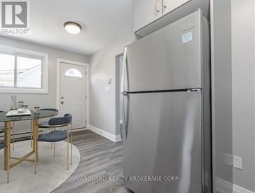 Cambridge fourplex for rent - A kitchen with a table and chairs and a refrigerator.