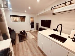 Toronto (Caledonia-Fairbank) apartment for rent - A modern kitchen with white cabinets and a black sink.