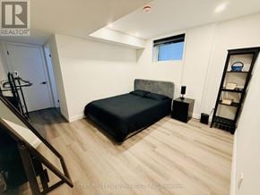 Toronto (Caledonia-Fairbank) apartment for rent - A bedroom with a bed, nightstand, and a window.