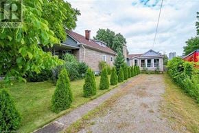 Niagara Falls (Dorchester) apartment for rent - A gravel driveway leads to a house with a well-maintained lawn and trees.