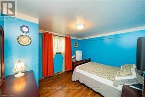 Niagara Falls (Dorchester) apartment for rent - A bedroom with a bed, nightstand, and a lamp.