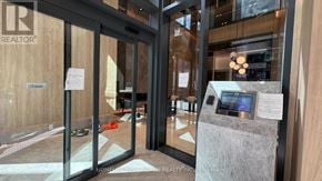 Toronto (Church-Yonge Corridor) condo for rent - The image shows the entrance to a REALTOR office with glass doors and a reception desk with a digital display.
