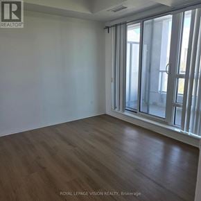 Toronto (Henry Farm) condo for rent - A room with wooden flooring and a sliding glass door.