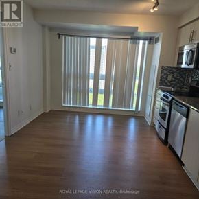 Toronto (Henry Farm) condo for rent - A kitchen with white cabinets and a wooden floor.