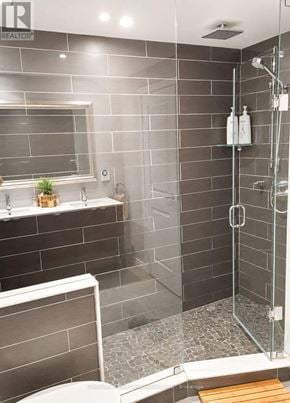 Toronto (Church-Yonge Corridor) condo for rent - A bathroom with a walk in shower and a toilet.