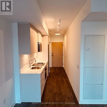 Toronto (Regent Park) condo for rent - A kitchen with white cabinets and a sink.