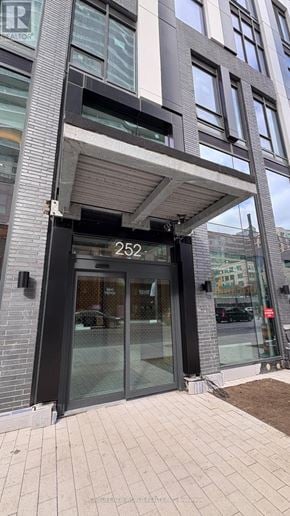 Toronto (Church-Yonge Corridor) condo for rent - The entrance to a building with a glass door and a number 252 on it.