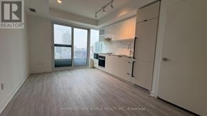 Toronto (Church-Yonge Corridor) condo for rent - A spacious kitchen with white cabinets and a view of the city.