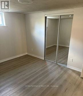 Oshawa (Lakeview) apartment for rent - A room with a sliding door and wooden flooring.