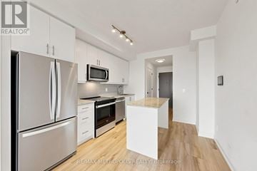 Oakville (Jm Joshua Meadows) condo for rent - A kitchen with white cabinets and stainless steel appliances.