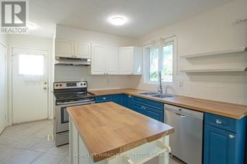 London North (North I) apartment for rent - A kitchen with a wooden counter top and stainless steel appliances.