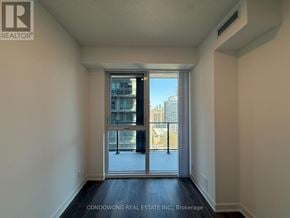 Toronto (Moss Park) condo for rent - A room with a sliding glass door leading to a balcony.