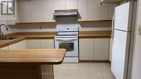 Mississauga (Fairview) apartment for rent - A kitchen with a stove top oven and a refrigerator.