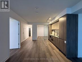 Toronto (Moss Park) condo for rent - A spacious room with wood flooring and modern furnishings.