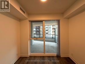 Toronto (Moss Park) condo for rent - A room with a large window and a sliding glass door.