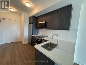 Clarington (Bowmanville) condo for rent - A kitchen with a sink and cabinets.