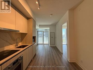 Toronto (Moss Park) condo for rent - A kitchen with a sink, stove, and cabinets is shown.