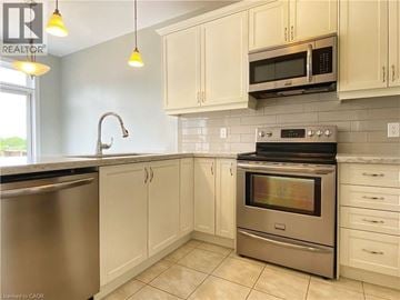 Hamilton apartment for rent - A kitchen with white cabinets and a stainless steel dishwasher.