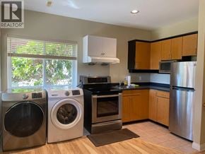 Coquitlam apartment for rent - A kitchen with a washer and dryer in it.