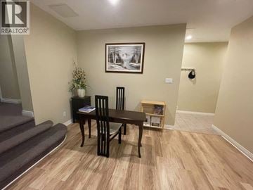 Coquitlam apartment for rent - A dining room with a wooden table and chairs.