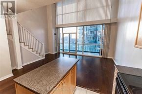 Mississauga (City Centre) condo for rent - A kitchen with a granite countertop and a staircase.