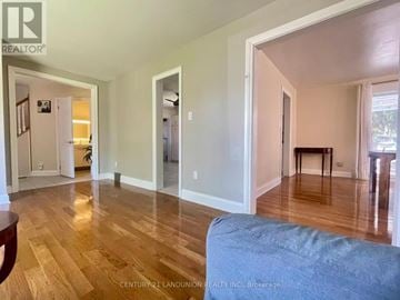 Oshawa (Lakeview) apartment for rent - A living room with a couch and a dining table.