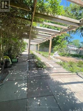 Oshawa (Lakeview) apartment for rent - A walkway with a metal roof and a brick floor.