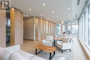 Peterborough (Ashburnham Ward 4) condo for rent - A spacious living room with a long wooden table and white chairs.