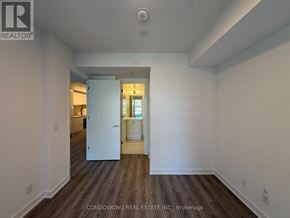 Toronto (Moss Park) condo for rent - A spacious room with a doorway leading to another room.