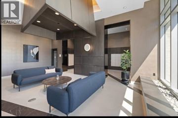 North Vancouver apartment for rent - A living room with a blue couch and a coffee table.