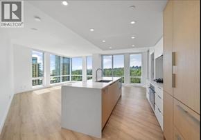 North Vancouver apartment for rent - A modern kitchen with wooden floors and white cabinetry.