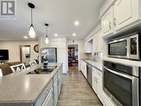 Hamilton (Waterdown) apartment for rent - A modern kitchen with stainless steel appliances and a central island.
