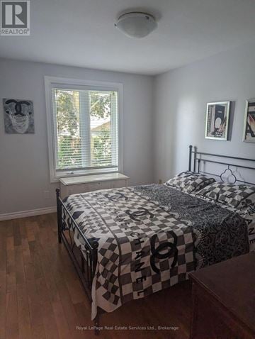 Hamilton (Waterdown) apartment for rent - A bedroom with a bed and a window.
