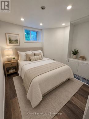 Hamilton (Centremount) apartment for rent - A bedroom with a large bed, a nightstand with a lamp, and a framed picture on the wall.