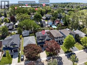 Oakville apartment for rent - A bird's eye view of a residential area with houses and trees.