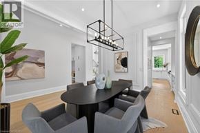 Oakville apartment for rent - A modern dining room with a black table and grey chairs.