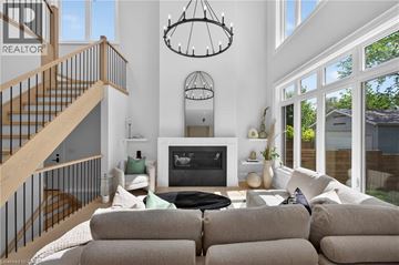 Oakville apartment for rent - A living room with a grey couch and a fireplace.