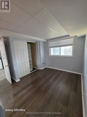 Oshawa (Pinecrest) apartment for rent - A room with wood flooring and white walls is labeled as "Galaxy S25 Ultra".