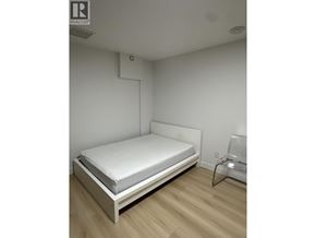 Burnaby townhouse for rent - A white bed with a white mattress in a room with white walls.
