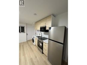 Burnaby townhouse for rent - A modern kitchen with a stainless steel refrigerator, dishwasher, and oven.
