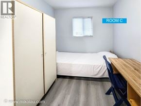 Vancouver apartment for rent - A bedroom with a bed, desk, and wardrobe.