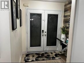 Brampton (Fletcher's Creek Village) apartment for rent - A glass door with a handle is in the middle of a room.