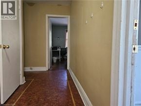 Hamilton apartment for rent - A hallway with a door on the left and a doorway in the distance.